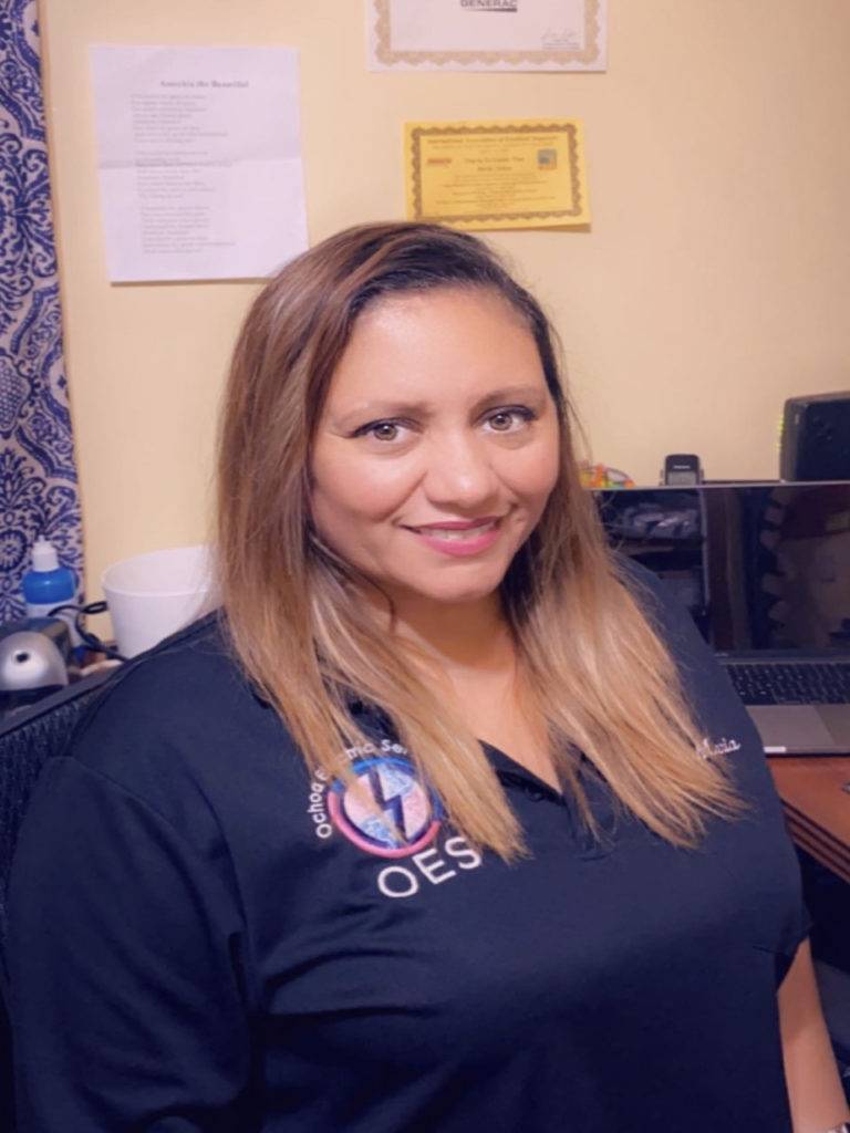 Office manager Maria providing customer support for a commercial electrical contractor at Ochoa Electric Services in Palm Beach County.