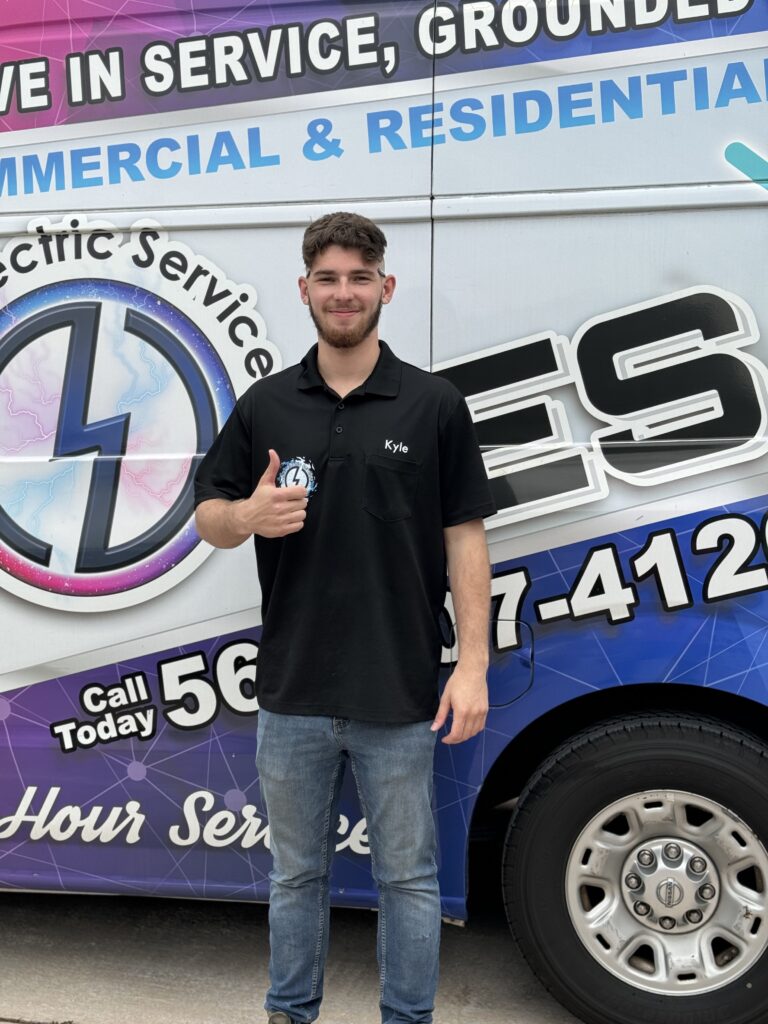 Certified electrician David from Ochoa Electric Services standing beside service van, ready to provide Emergency electrical repair services for residential and commercial clients.